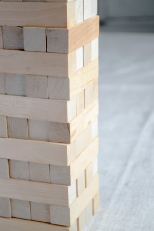 Tower is a game for leisure. Board game - a tower of wooden bars. Interesting entertainment wooden construction tower.の写真素材