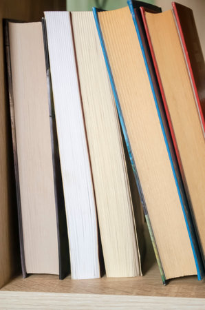 Books are on the shelf. Pages of books ahead. Books are falling. Lots of books together. Books pages ahead. Folded books, no spine is visible.の写真素材