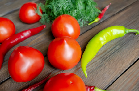 Healthy summer vegetables on a wooden table. chili pepper. tomatoes and dill on a wooden table. variety of vegetables.の写真素材