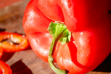 Red pepper on a wooden board. Bright, healthy vegetables. A constrate photo of a bell pepper with a red skin on a wooden board in the dark.の写真素材