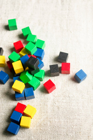Bright children's cubes. children's cubes made of wood. Colored cubes on the fabric. On the table there are many colored cubes for the game.の写真素材