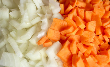 Carrots and onions - background photo. Chopped vegetables - onions and carrots background image. Equally chopped onions and carrots.の写真素材