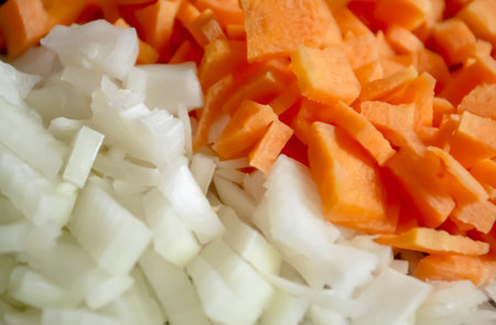 Carrots and onions - background photo. Chopped vegetables - onions and carrots background image. Equally chopped onions and carrots.の写真素材