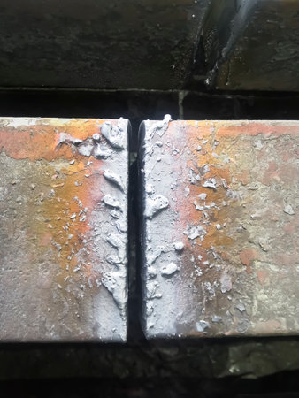 rubber-cut metal. Production of a square of cast steel at a metallurgical plant. black metal - cut square.の写真素材