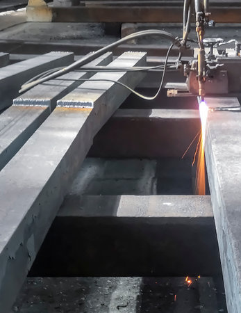 Metallurgical plant - metal processing. The workpiece is processed by a gas-cutting machine. Cutting a square before processing and sorting. Steel production at the plant.の写真素材