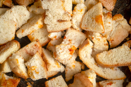 Homemade breadcrumbs in a pan with seasoning. crackers as an appetizer. Cook delicious breadcrumbs with different flavors on the stove. Seasoning on breadcrumbs.の写真素材
