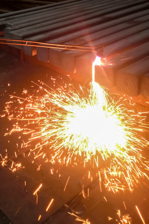 Metal processing at the factory. metallurgy. Work at a foundry metallurgical plant. The machine processes metal. Gas cutting machine for metal.の写真素材