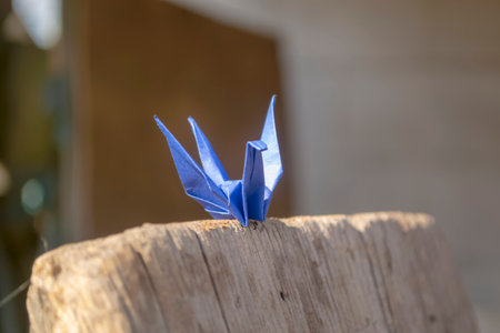 Blue paper crane on a wooden board. Beautiful paper crane. Fulfillment of desires - paper crane, Japanese origami.の写真素材