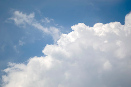Incredible clouds against the blue sky. White, curly clouds stand out in the blue sky. A delightful sky. Cloud close-up.の写真素材