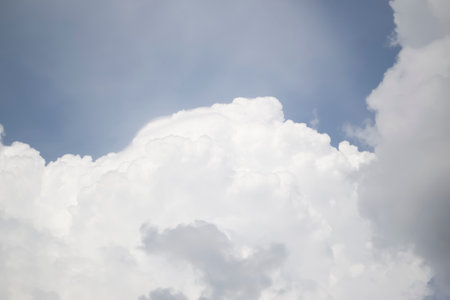 Large curly clouds of white color on a pale blue sky. Gentle clouds in the blue sky.の写真素材