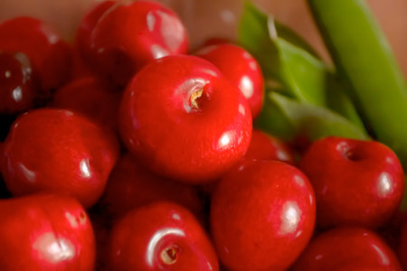 Summer berries next to green peas. Fresh cherry close-up. red cherry. A lot of bright cherries.の写真素材