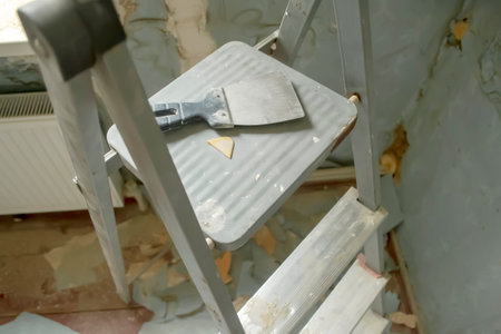 Renovation in the room - the spatula lies on the stairs. There is a small spatula on the stairs.の写真素材