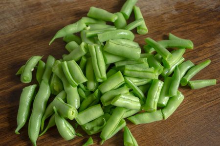 The Green legumes pods are chopped. Slicing bean pods. protein crops for vegetarians. Green asparagus is a source of protein.の写真素材