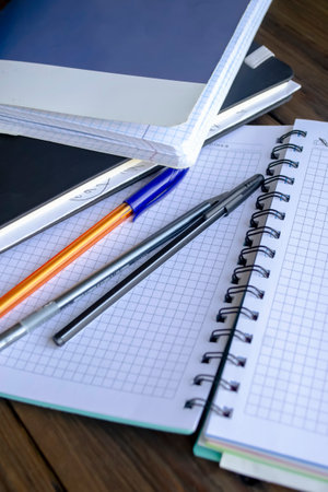 open notebooks with pens. Education at school - a pen and notebooks on a wooden table.の写真素材