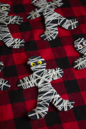 Mummy with his own hands on Halloween. Halloween decorations are a mummy. Halloween made of thread...