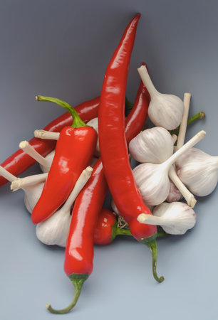 Hot pepper and garlic in a bowl. Spicy spices together. Red chili peppers and garlic heads.の写真素材