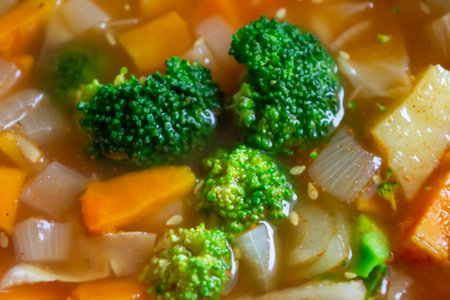 Tomato soup with broccoli. Close-up of broccoli in soup. Bright broccoli cabbage lies in the soup.の写真素材