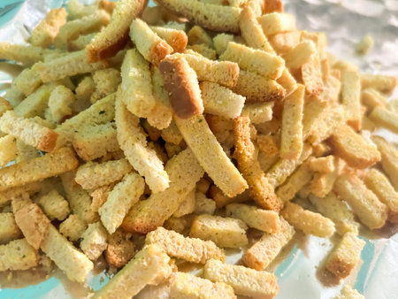croutons on foil. Junk food - crackers with different flavors. breadcrumbs. Food additives in crackers.の写真素材