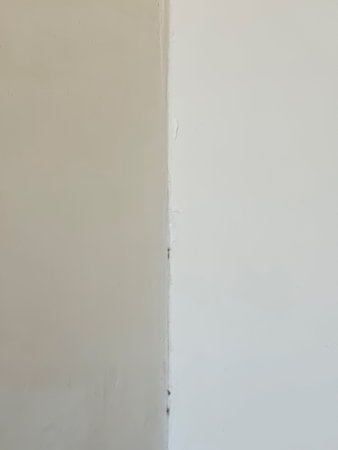 Corner of the room. Symmetry. The corner between two walls. white wall - corner in the center.の写真素材