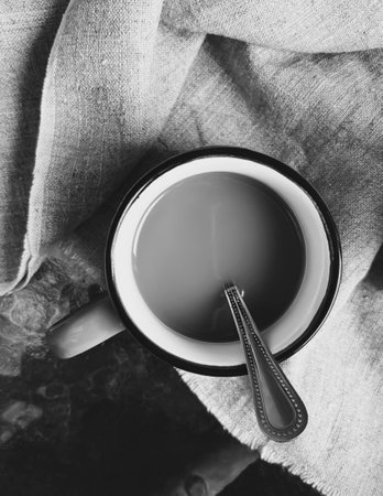 Cup of coffee black and white photo. A cup with a drink from top to bottom. Cup with spoon and drink, black and white top-down photo.の写真素材