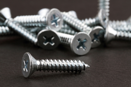 Screws on a dark background の写真素材