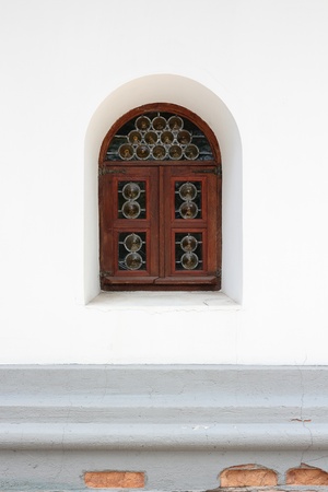 An old window on a white wall closeupの写真素材