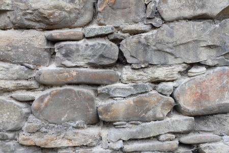 Fragment of old vintage brick or stone wall close-upの写真素材