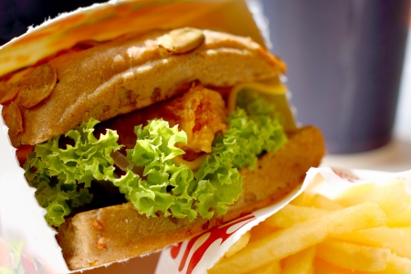 Sandwich with chicken vegetable chips and orange juice. A fragment of a menu of fast-food restaurant.の写真素材