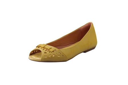 yellow female shoes closeup view from above on white backgroundの写真素材