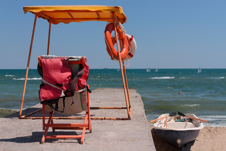 Rescue post and boat against the sea and blue sky of the seaの写真素材