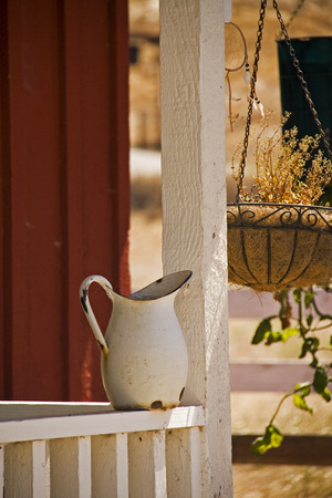 Still life with Vintage enamel pither on the countryside house entranceの写真素材