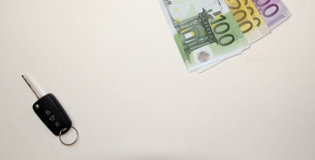 New Car key and Euro money on white background.の写真素材