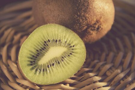Vintage Style image of Ripe  Kiwi fruits on the Straw Matの写真素材