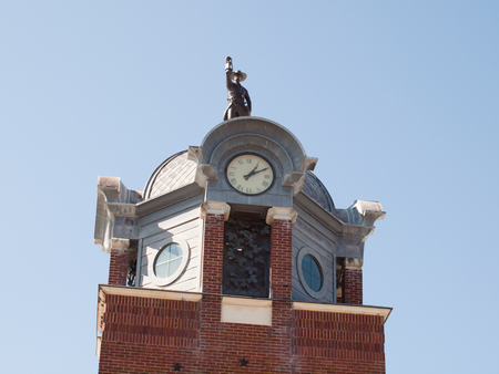 Statue atop the dome of a buildingの写真素材