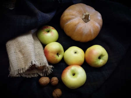 Autumn or Halloween October seasonal vegetables pumpkin and apples in the countrysideの写真素材