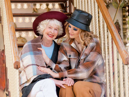 portrait senior woman with daughter spending nice nice together at amusement park. Lockdown is over, family, relationships, care, life after vaccination conceptの写真素材