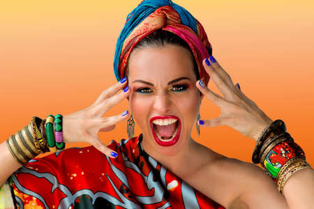 Portrait of screaming young attractive woman singer in african style on colorful background