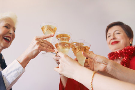 new year celebrating hands with glasses of white sparkling wine. Christmas, family, friends,...