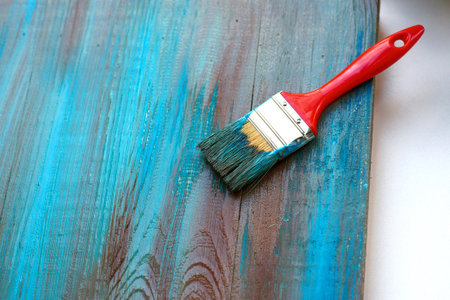 brush on blue and brown wooden background