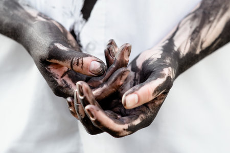 Dirty hands with black gold - oil. Pollution, eco, eco guilt, global warming, recycling conceptの写真素材