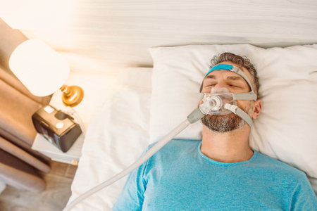 Sleeping man with chronic breathing issues considers using CPAP machine in bed. Healthcare,...