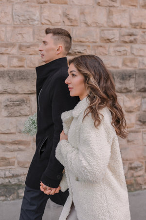 Beautiful couple in love, man and woman on the background of the stone wall.の写真素材