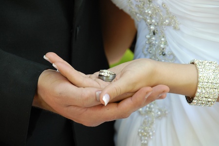 Bride   Groom holding wedding ringsの写真素材