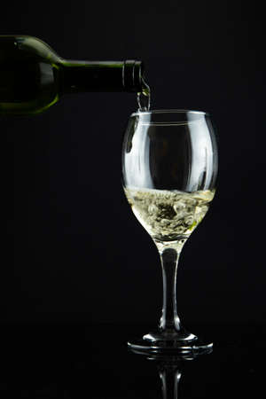 wine bottle and glass, black backgroundの写真素材