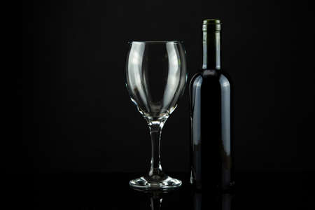 wine bottle and glass, black backgroundの写真素材