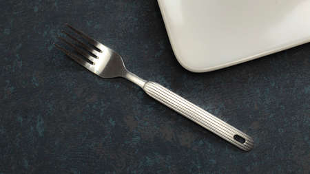Cutlery knife and fork on textured tableの写真素材