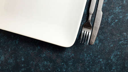 Cutlery knife and fork on textured tableの写真素材
