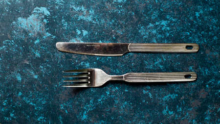 Cutlery knife and fork on textured table