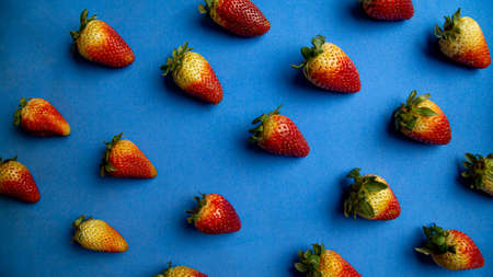 set of strawberries on blue textured backgroundの写真素材