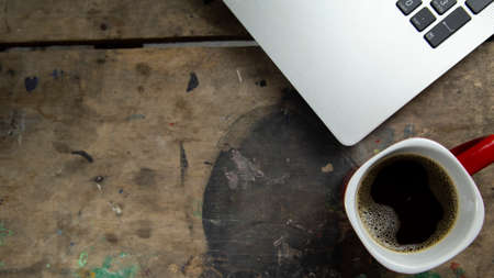 cup of coffee accompanied by plate on textured background
